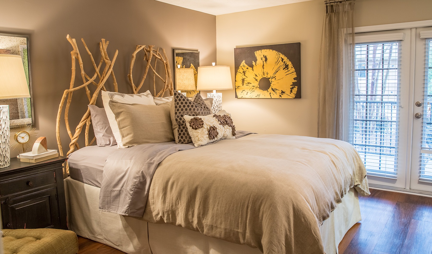 Living Begins Here bedroom with ample space around the bed and bright lighting